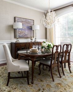 a dining room table with chairs and a chandelier