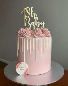 a pink cake with icing dripping from it and a happy birthday sign on top