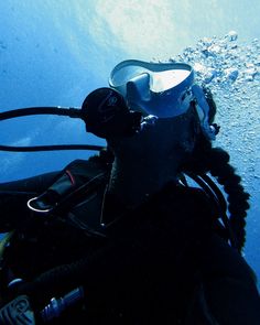 a scuba diver in the water with his gear on