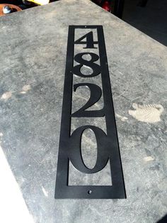 a metal number sign sitting on top of a table