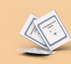 two white cards sitting on top of each other with the words conversation cards coming out of them