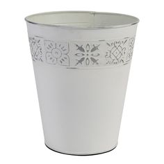 a white flower pot with an intricate design on the rim and bottom, sitting in front of a white background