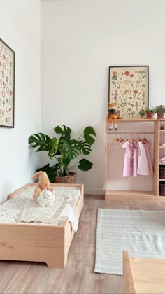 a child's bedroom with white walls and wooden floors