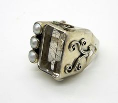 Estate Vintage 1940's Sterling Silver Huge 15.35 Carat Rutilated Quartz Pearl Statement Ring. This lovely size 7 ring is stamped 925. It weighs 14.5 grams. The large step cut rectangle rutilated quartz is absolutely stunning. The stone measures 18.2 mm X 13.4 mm  inches  X 9.5 mm and it is and full of sparkle. It holds three 5.2 mm pearls. This stunning ring is in excellent condition (please see picture of normal wear) and absolutely brilliant!!  Perfect for a collector. Please visit my ebay store for unique estate jewelry. Thank you. Brazil Festival, Step Cut, Cabochon Ring, Contemporary Jewellery, Rutilated Quartz, Estate Jewelry, Statement Ring, Statement Rings, Ebay Store