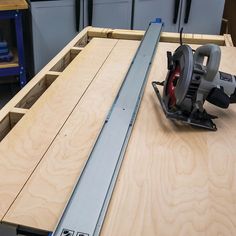 a circular saw sits on top of a piece of plywood