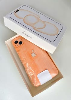 an apple phone in its box on the table