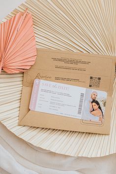 a brown envelope with a pink fan next to it