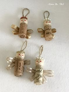 three wine cork angel ornaments hanging from strings