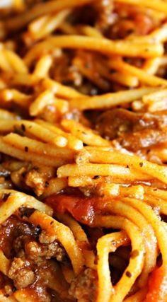 spaghetti with meat and tomato sauce on a white plate