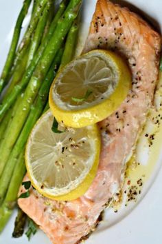 salmon and asparagus on a plate with lemons