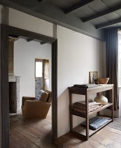 a living room with wooden floors and white walls