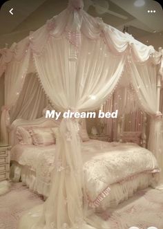 a bed with white curtains and lights on it