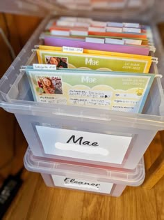 a plastic container filled with files on top of a wooden table