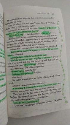 an open book with green writing on it