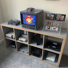 an entertainment center with video game consoles and games