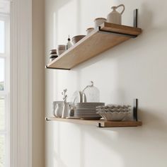 two wooden shelves with dishes and cups on them