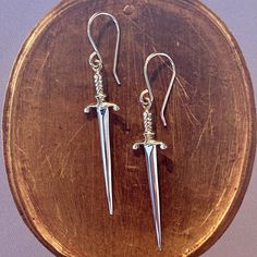 Timeless yet edgy, these double edged sword earrings will be your next jewelry favorite! Crafted in sterling silver and 14k gold vermeil, these swords are lightweight and wearable! The texture and detail on these shimmer magically in the light. Crafted in 14k yellow vermeil and sterling silver Sword measures approx. 35mm in length Available on 14k gold fill ear wire Because our jewelry pieces are all made entirely by hand, we can offer a wide array of customization! Click here to inquire about t Ear Wire, Swords, Custom Engraving, Gold Vermeil, Jewelry Pieces, Gold Filled, Anthropologie, Ruby, Texture