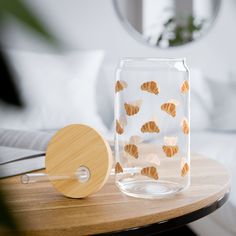 a table with a glass jar and wooden paddle on it, next to a mirror