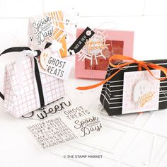 three small gift bags with tags on them