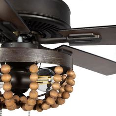 a ceiling fan with wooden beads hanging from it's blades and two lights on each side