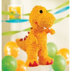 there is a stuffed toy dinosaur that is on the table with balloons and streamers