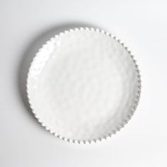 an empty white bowl sitting on top of a table