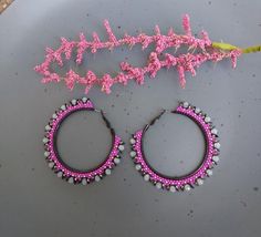 These Beaded Hoop Earrings are made with high quality Miyuki seed beads on 2 inch black hoop with a lever back. Light weight and fun to wear! Black sequins and crystals with silver accents beads top them off. The photos don't do these justice.   100% handmade with my passion for beading and attention to detail. Each piece can take hours to complete. They would make a great gift for you or someone special. Great to wear for any occasion. Go in style wherever you go! Please check out the many other listings in my shop! https://barbsbeadingstudio.etsy.com Handmade in the heart of Oklahoma, USA I've made every effort to get accurate photos so you can see all the details. If you still have any questions, please message me and I will be glad to help you. Thank you for visiting and happy shopping Beaded Hoop Earrings Tutorial, Hoop Earrings Diy, Big Hoop Earrings, Earring Ideas, Back Light, Handmade Gifts For Her, Bead Work Jewelry, Earring Tutorial, Beaded Top