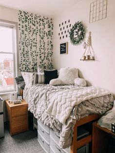 an unmade bed in a dorm room next to a window