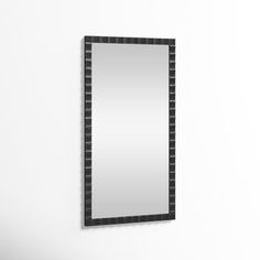 a mirror mounted to the side of a wall