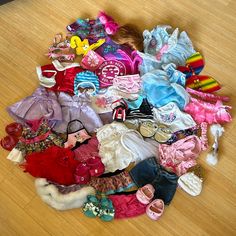 a pile of children's clothing and shoes on the floor