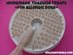 a spool of dog treats sitting on top of a pink surface with the words homemade training treats for allergic dogs