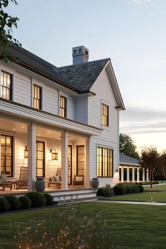 a large white house sitting on top of a lush green field