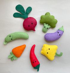 felt vegetables arranged in a circle on a white surface