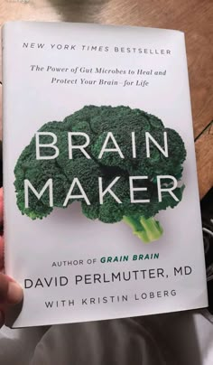 the book brain maker by david permuter is being held in front of a table