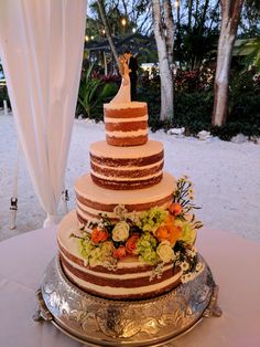 a wedding cake sitting on top of a silver platter