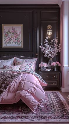 a bed with pink comforter and pillows in a room next to a painting on the wall