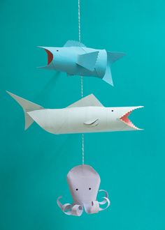 two paper fish and an octopus hanging from strings