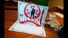 someone is making a card with the silhouettes of two people in front of them