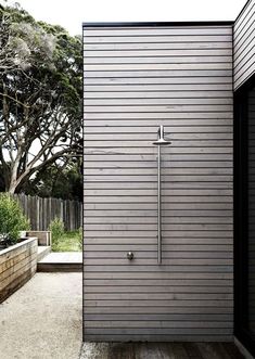 an outdoor shower in the middle of a yard