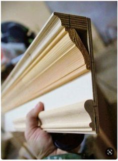 a person holding an open book in their hand