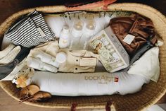 a basket filled with personal care items on top of a wooden table next to a pair of shoes