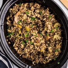 a close up of a pot filled with rice and meat