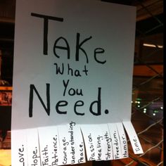 a sign that says take what you need with several notes attached to the back of it