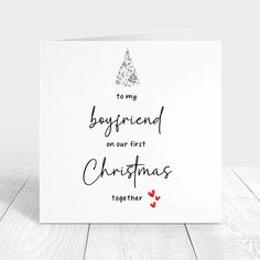 a white christmas card with the words to my boyfriend on our first christmas together in black ink