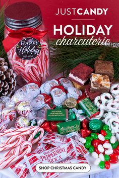 christmas candy and candies are on display in front of a red sign that says just candy holiday charlotte