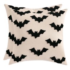 two black and white pillows with bats on them