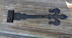 an old metal door handle on a wooden surface