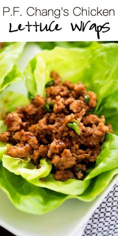 lettuce wraps filled with ground meat on a white plate and text that reads p f chang's chicken lettuce wraps