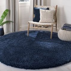 a living room with a blue rug and chair