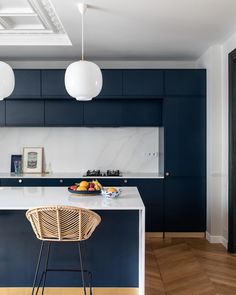 a kitchen with blue cabinets and white countertops is featured in this article by interior stylist